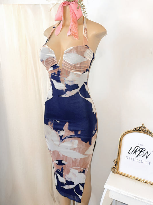 Midnight Muse halter midi dress in navy, cream, and light peach with a high slit, featuring a flattering silhouette designed for elevated nights and special occasions.