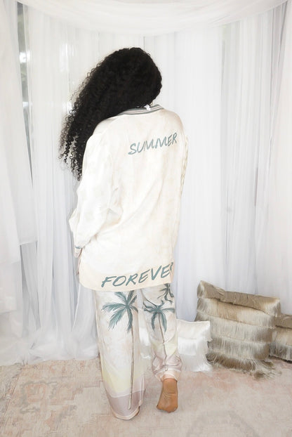 Back view of Summer Forever two piece resort pant set showing  text on the top and bottom of shirt that reads "Summer Forever" in a relaxed fluid fit.