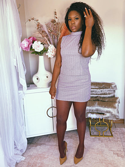 The Chelsea Mod Set plum tweed two-piece with a structured tie top and mini skirt, styled for modern mod glamour.