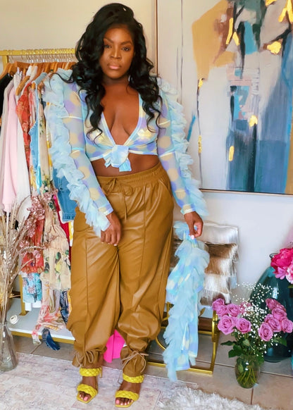 The Color Me Baddie crop top is a sheer tie up multicolored polka dot ruffle trimmed crop top. We can see in now! This multi-colored sheer crop top is a whole spring or summer music festival vibe. The colors included in the crop top consists of yellow, blue, and green. The light blue fringe trim shoulders and arms for a defined yet fun silhouette. Suggested styling would be with super cute pasties or a cute bra that deserves to be displayed.